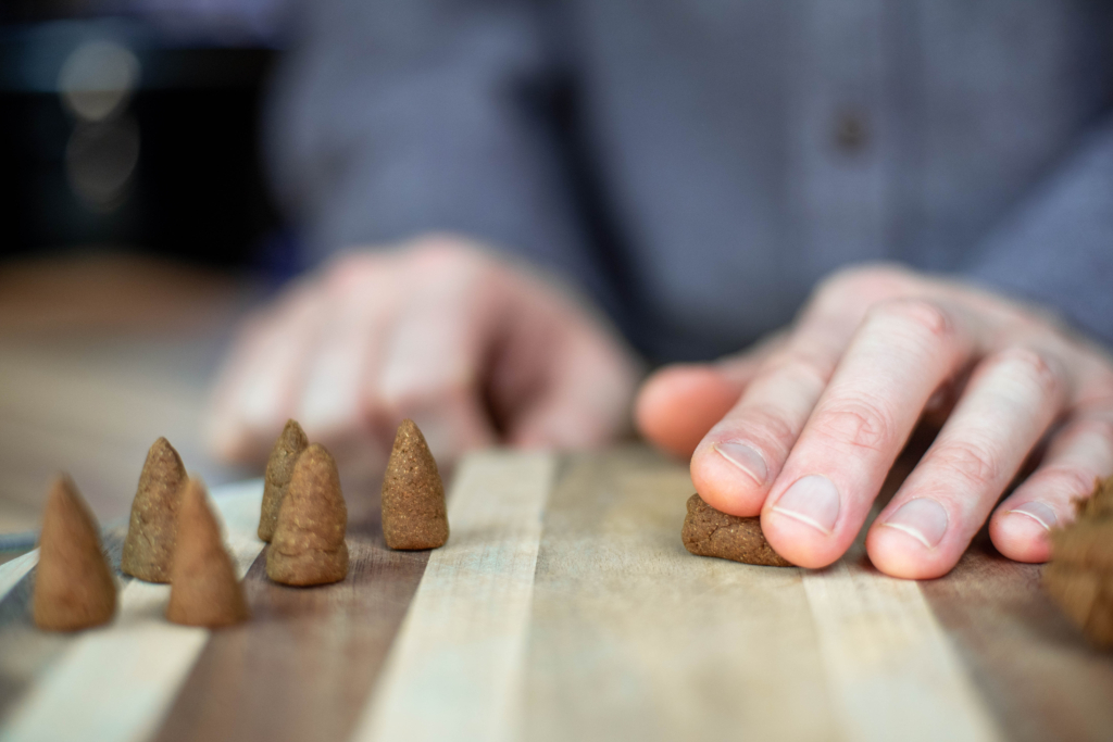 cone making hand rolling natural incense into cones